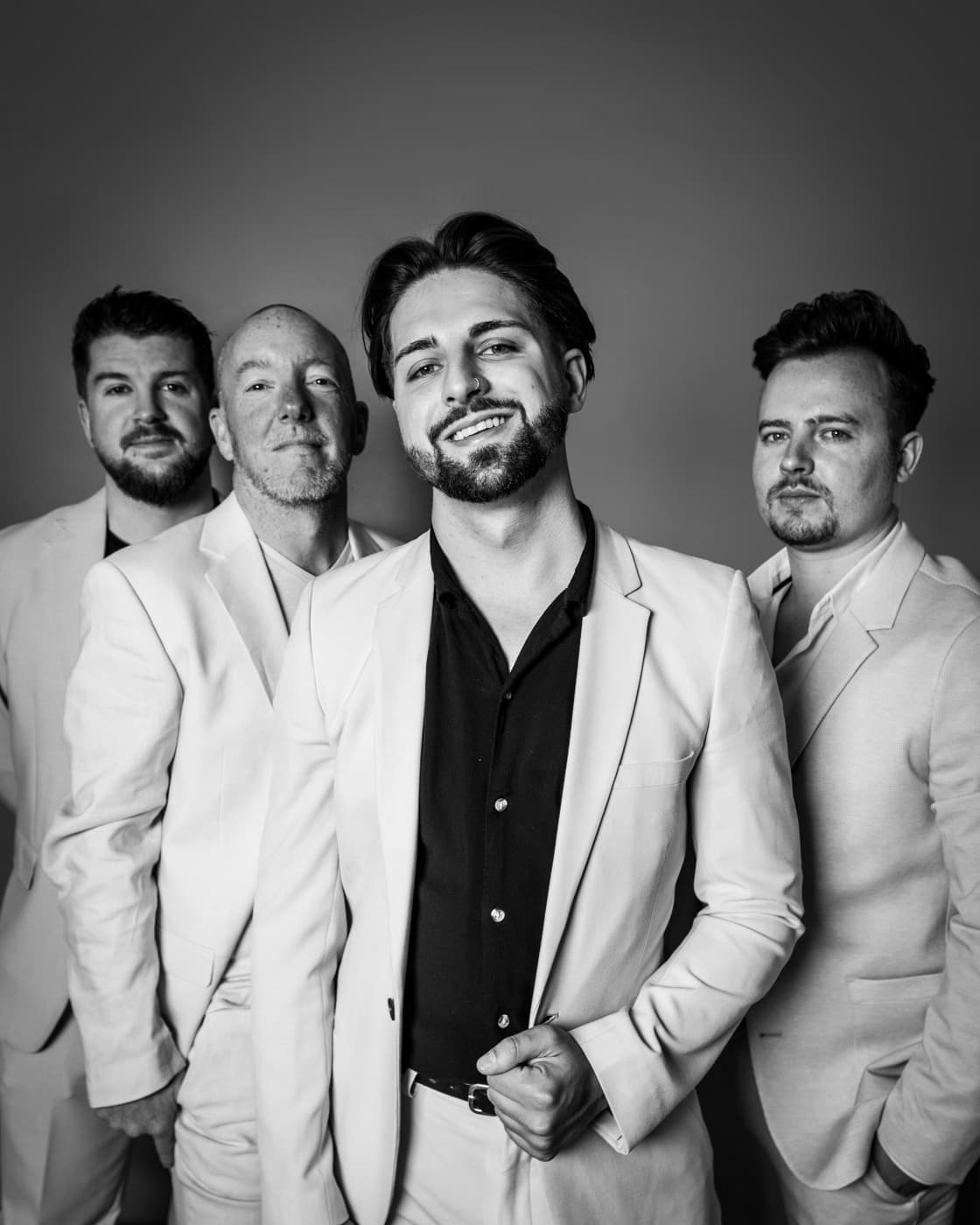 Miami Beat in cream suits, black and white studio portrait